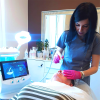 a beautician is opreating a hydrafacial machine